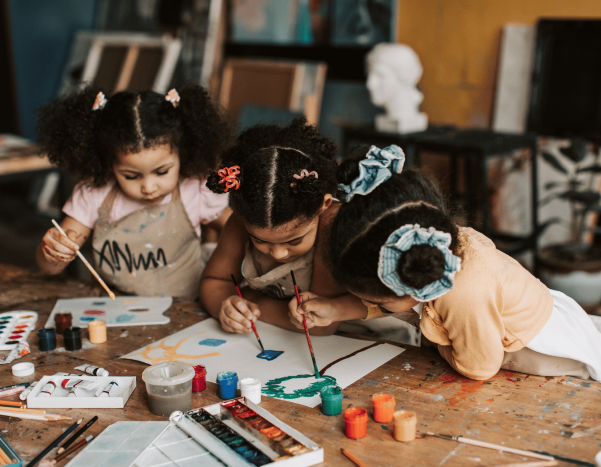 Group of young children painting with watercolors